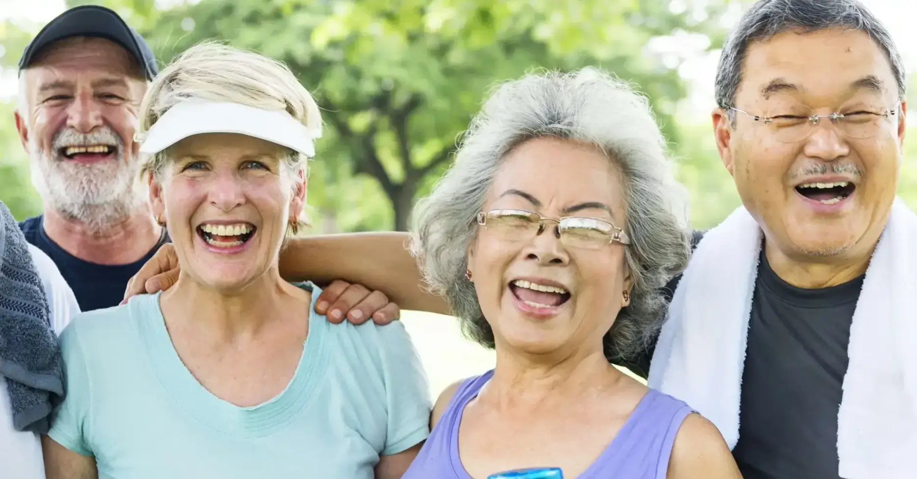 A group of seniors happily smiling and holding water bottles.