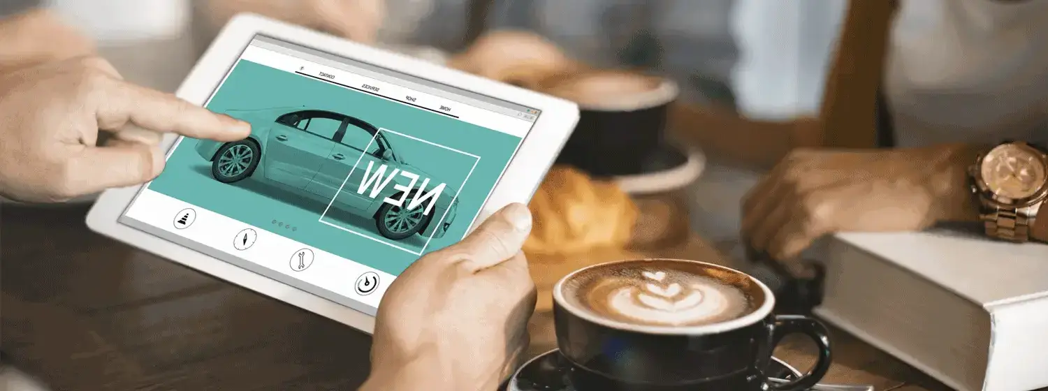 A person holding a tablet, clicking on an image of a car.