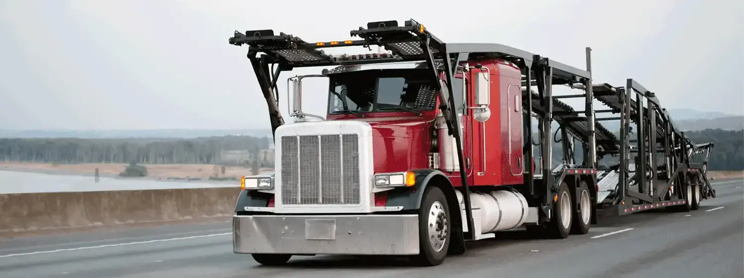 a semi truck with a car carrier trailer attached to it.