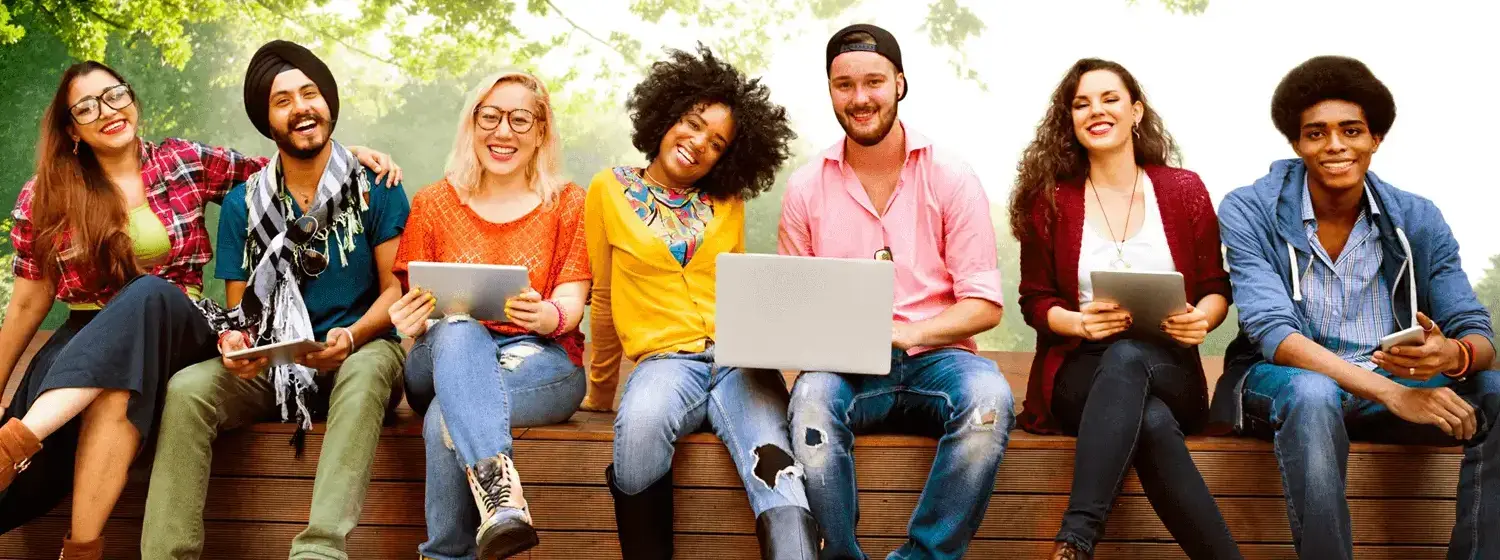A diverse group of people sitting and smiling at the camera.