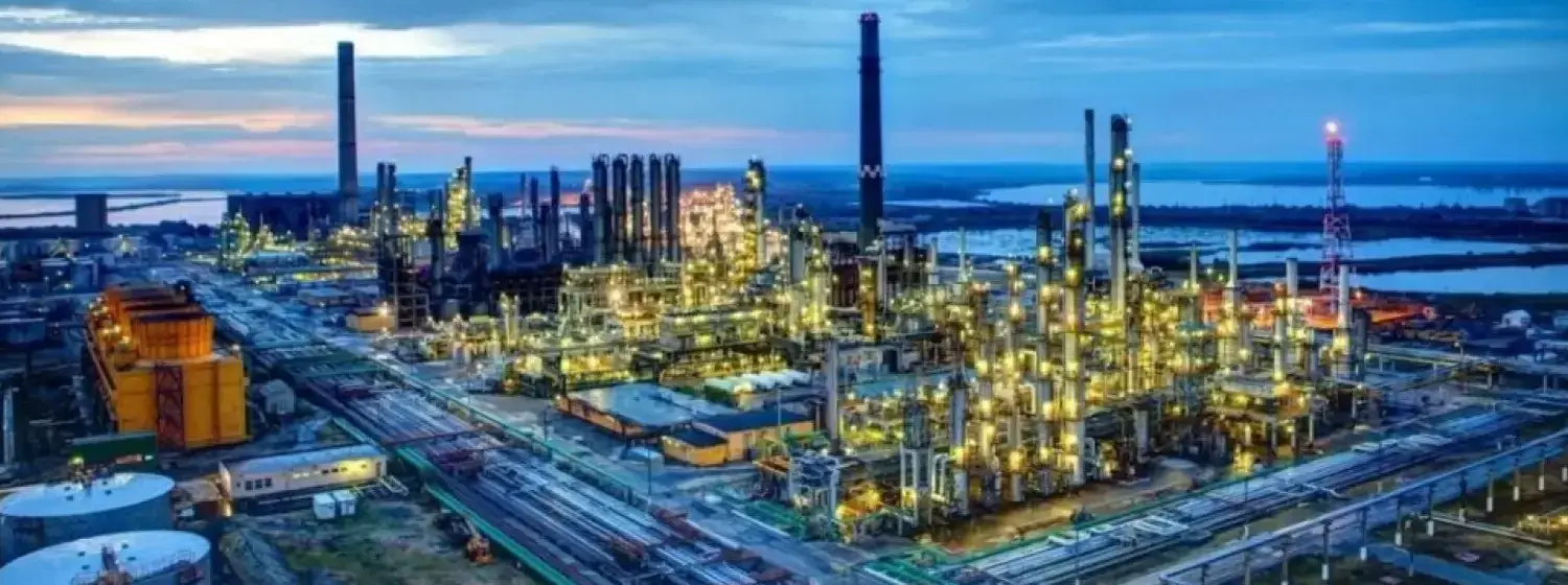 An aerial view of the Pine Bend oil refinery in Rosemount, Minnesota, showing a network of pipes, storage tanks, and industrial buildings.
